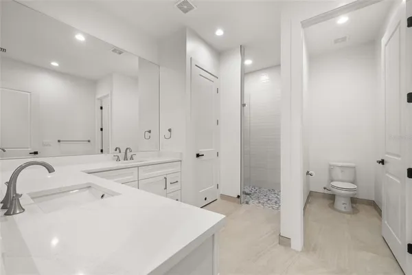 a bathroom with double sink and a mirror