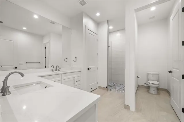 a bathroom with double sink and a mirror