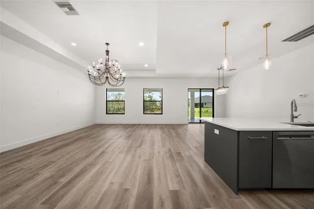 a view of a room with chandelier and wooden floor
