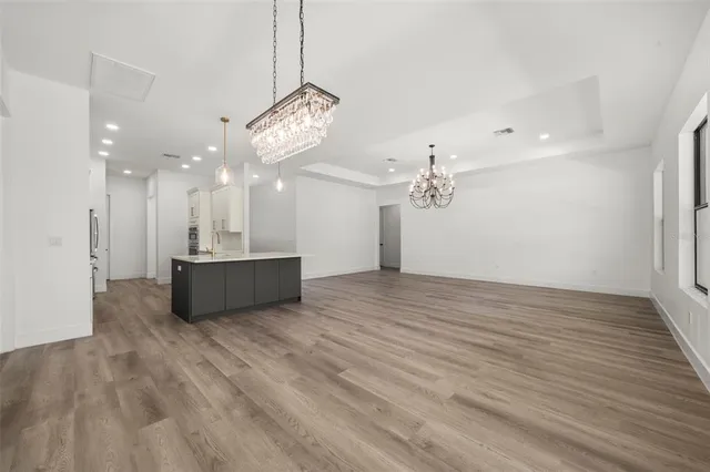 a kitchen with kitchen island white cabinets and refrigerator
