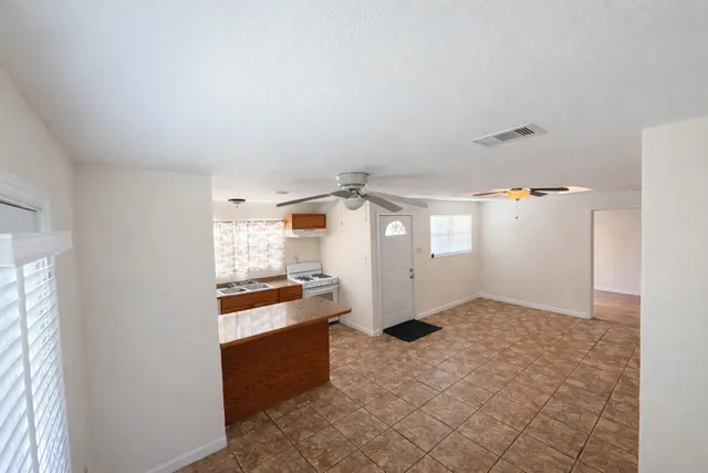 a kitchen with granite countertop a refrigerator and a stove