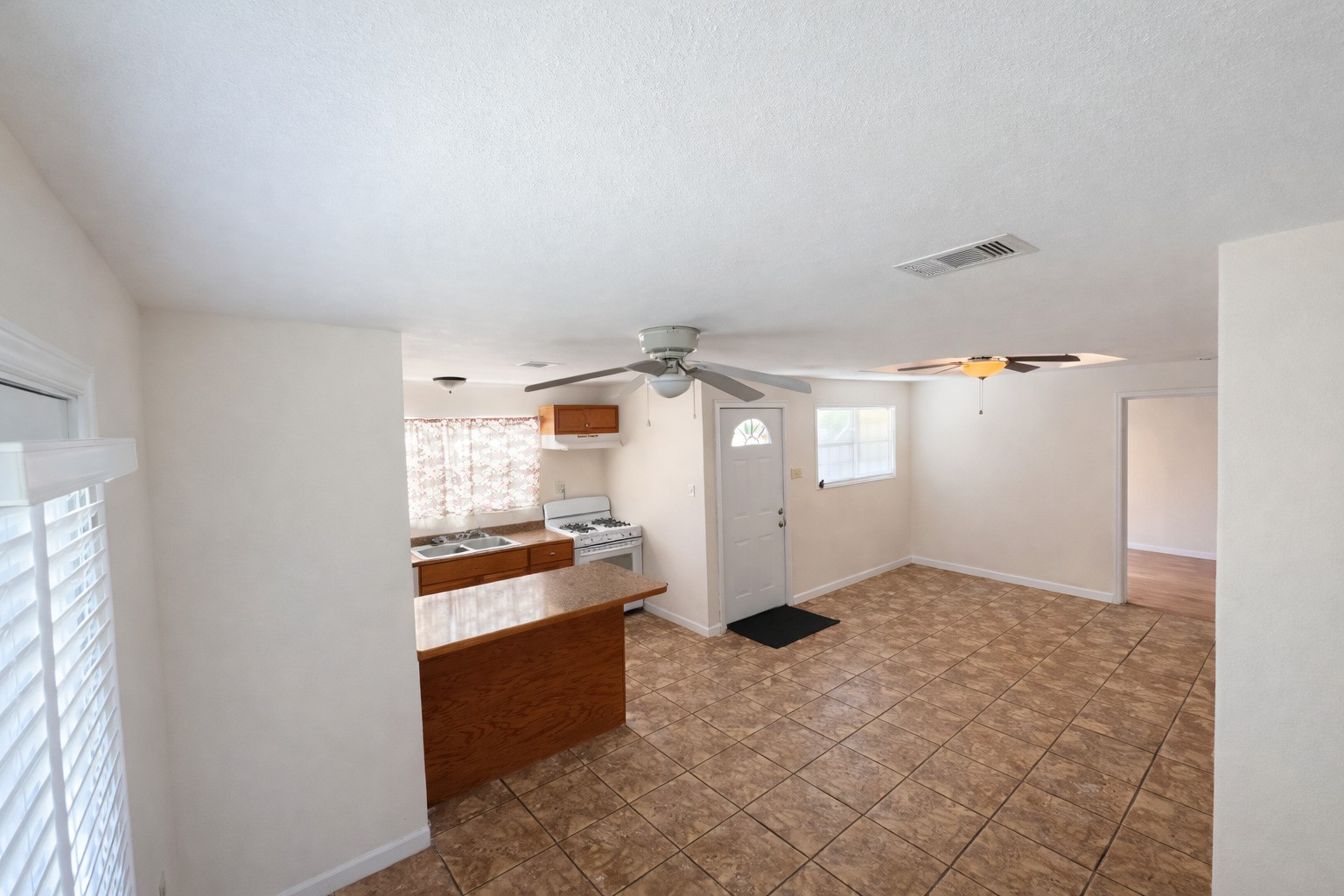 612 Harvey Street Clute, TX 77531 - Photo 4 of 12 a kitchen with granite countertop a refrigerator and a stove