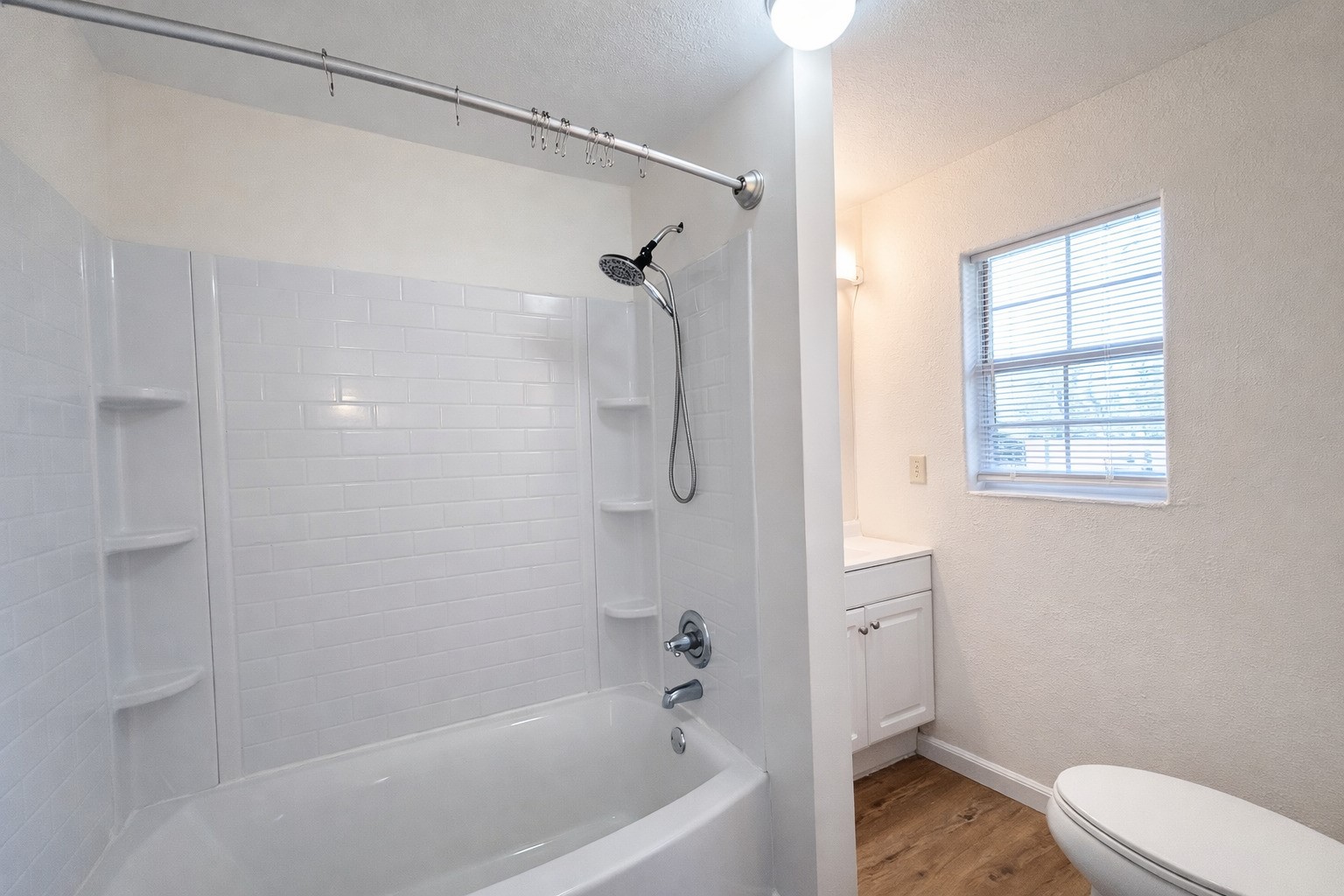 612 Harvey Street Clute, TX 77531 - Photo 8 of 12 a bathroom with a bathtub and a shower