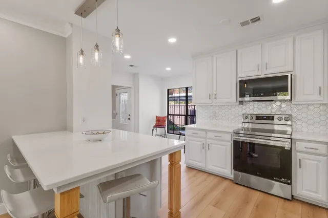 a kitchen with a sink a stove and microwave