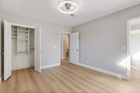 a view of a room with wooden floor and window
