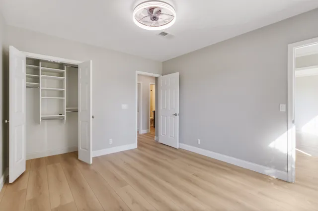 a view of a room with wooden floor and window