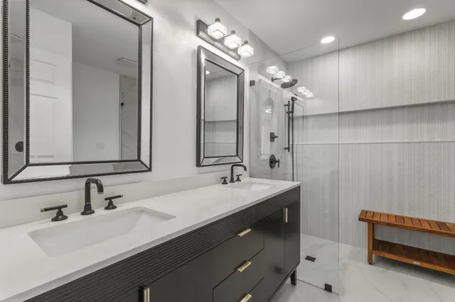 a bathroom with a double vanity sink mirror and double