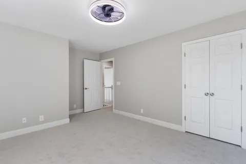 an empty room with a fan