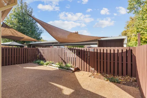 a view of a backyard with wooden fence