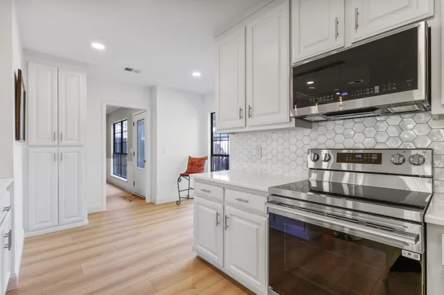 a kitchen with a stove and a microwave