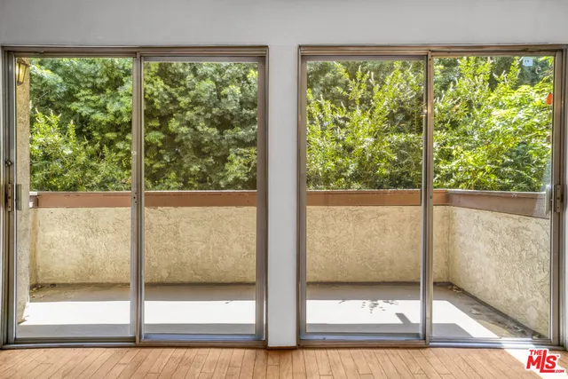 a view of balcony with wooden floor