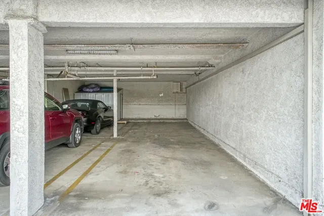 a view of a street with plants and large trees