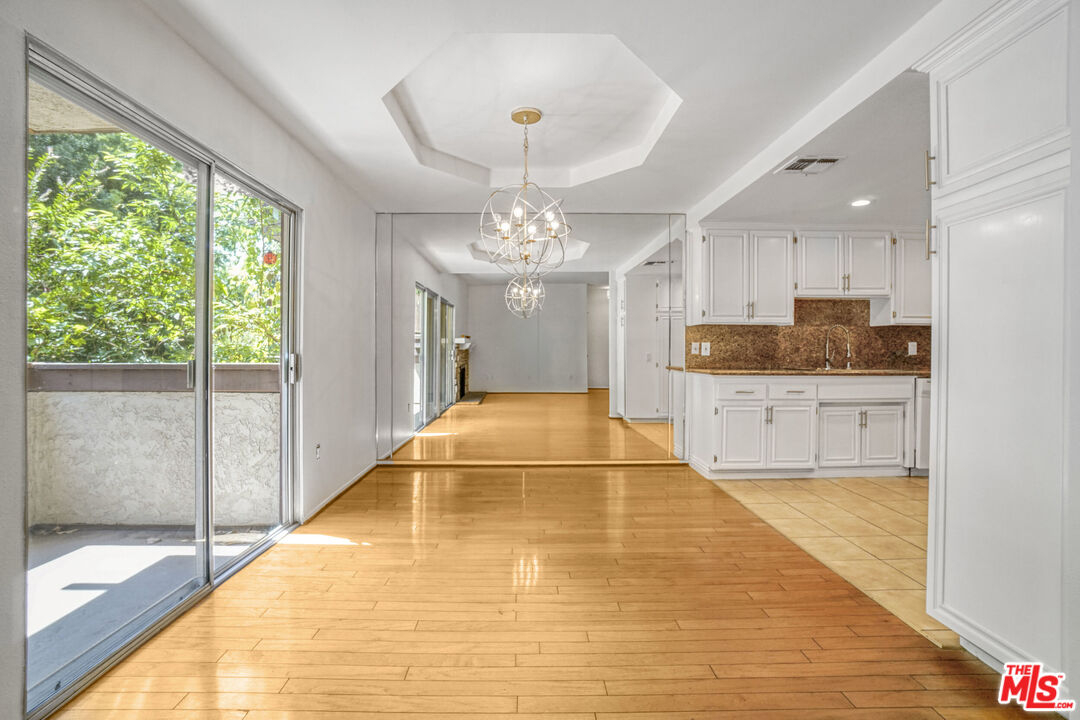 5534 Sylmar Avenue, Unit 5 Sherman Oaks, CA 91401 - Photo 5 of 33 a large swimming pool with a large window and chandelier
