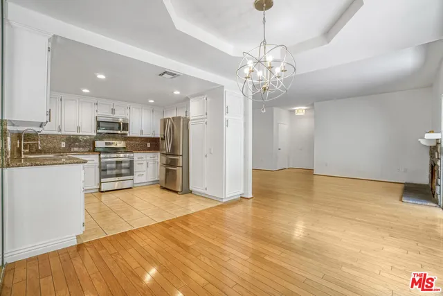 a view of a kitchen with a stove cabinets and wooden floor