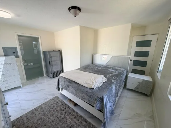 a bed sitting in a room next to a window
