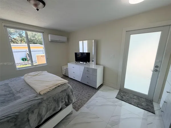 a bedroom with two beds and a window