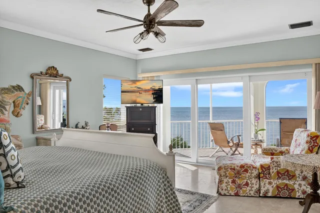 a living room with furniture large window and flat screen tv