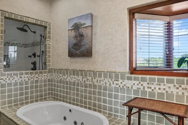 a bathroom with a bathtub and shower