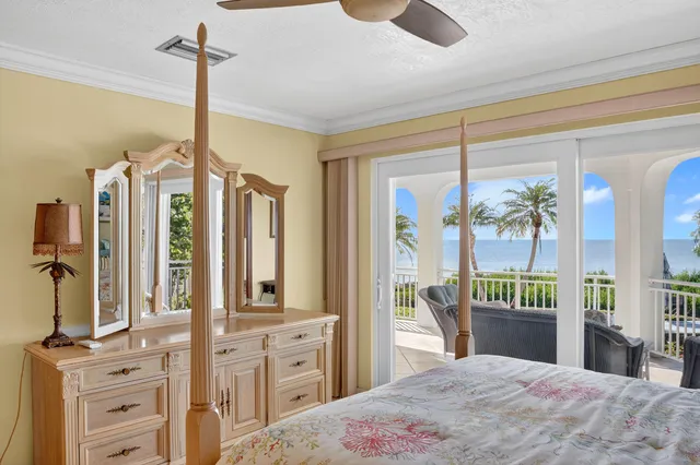 a bedroom with a bed a table and large mirror