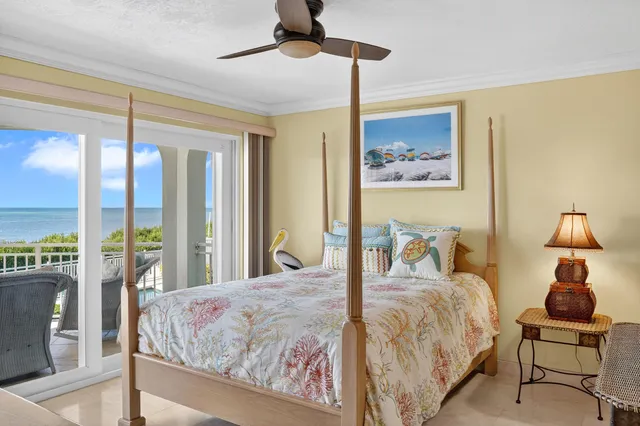 a bedroom with a bed and glass walk in closet