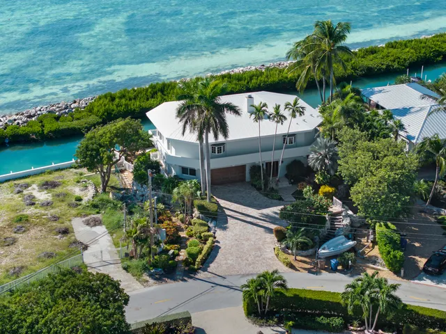 a view of a house with a garden and a yard