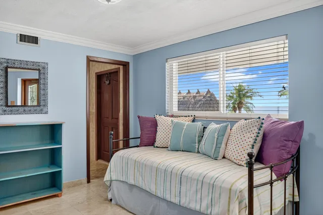 a bedroom with a large bed and a window