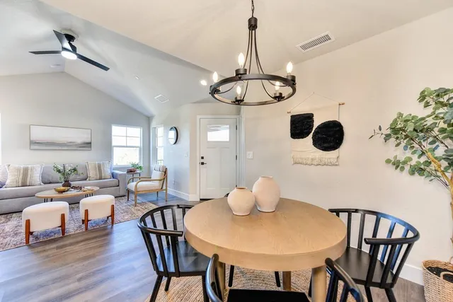 a view of a dining room with furniture wooden floor and chandelier