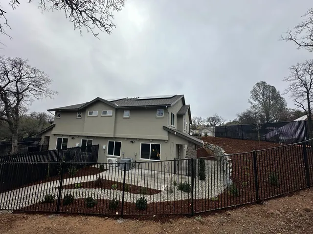 a living room with furniture kitchen view and a table