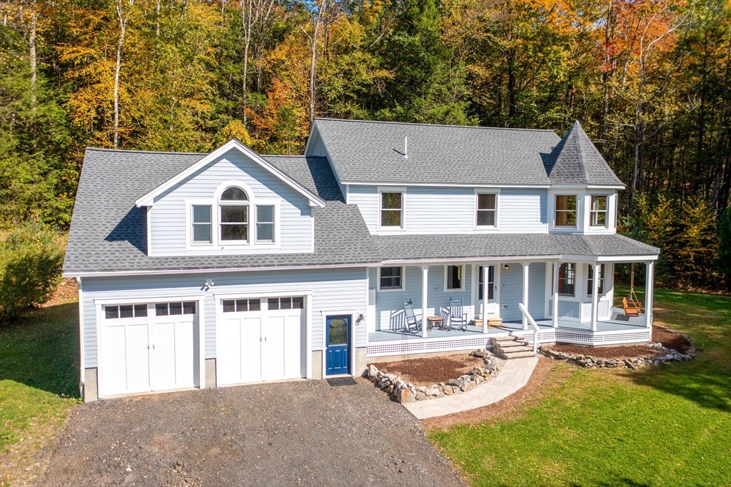 a front view of a house with a yard table and chairs