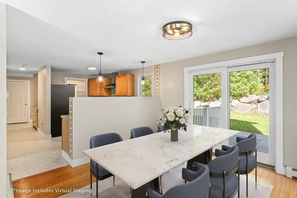 a view of a dining room with furniture window and wooden floor