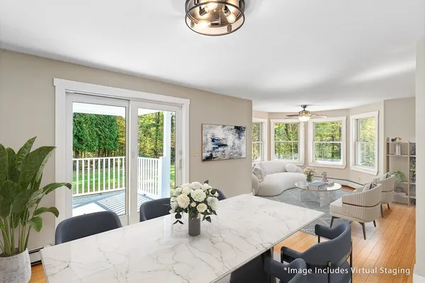 a living room with furniture a table and a large window