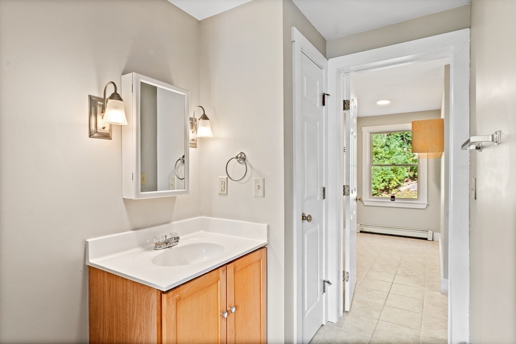 230 South Ashfield Road Conway, MA 01096 - Photo 22 of 35 a bathroom with a sink a mirror and a shower