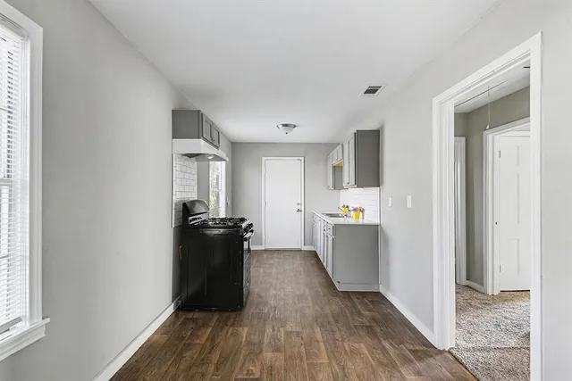 a kitchen with a refrigerator and a stove