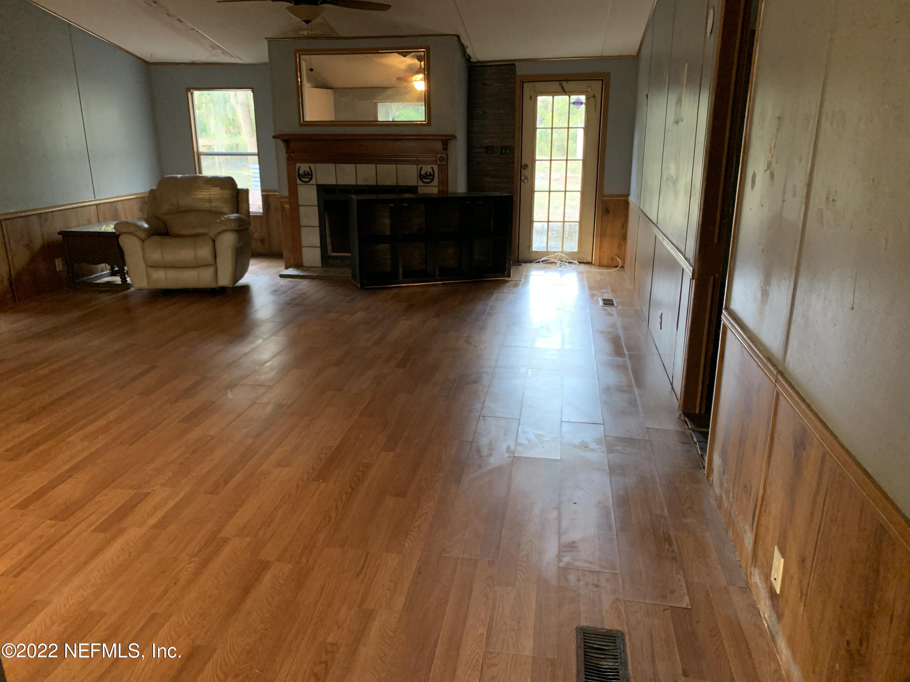 3163 Lannie Road Jacksonville, FL 32218 - Photo 14 of 36 a living room with furniture and a fireplace