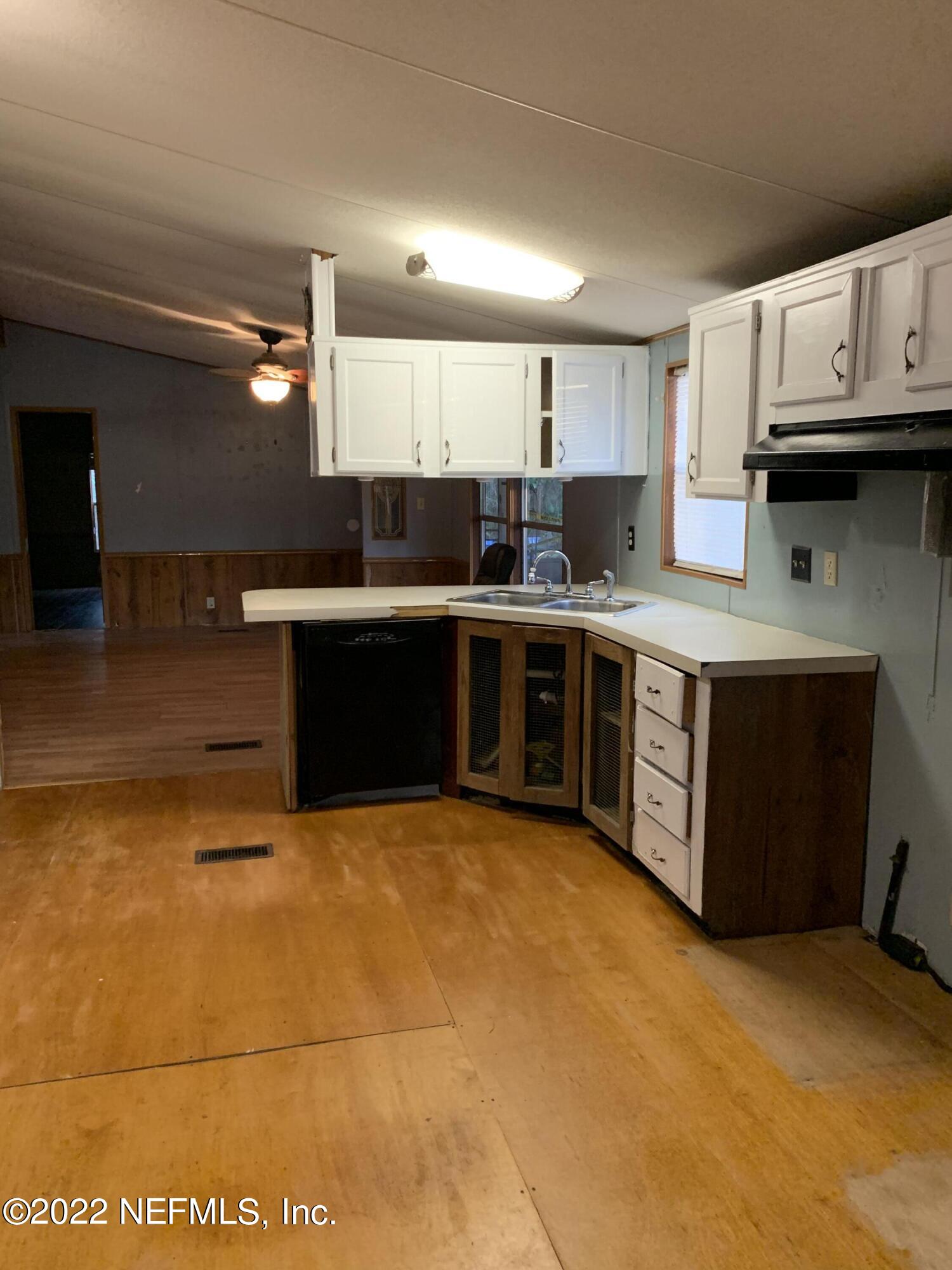 3163 Lannie Road Jacksonville, FL 32218 - Photo 21 of 36 a kitchen with stainless steel appliances granite countertop a sink cabinets and stove top oven