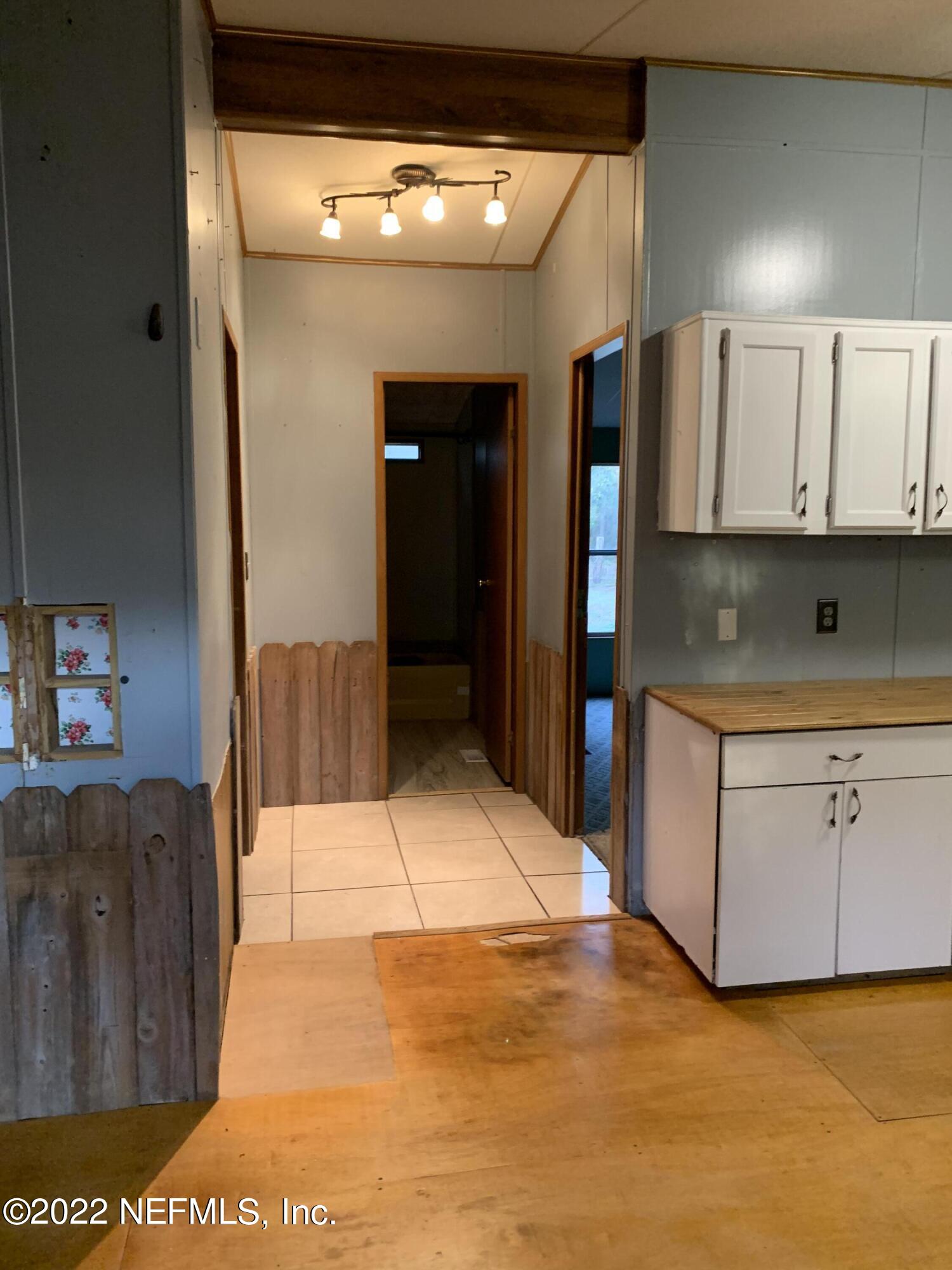 3163 Lannie Road Jacksonville, FL 32218 - Photo 25 of 36 a view of kitchen with granite countertop cabinets and black appliances
