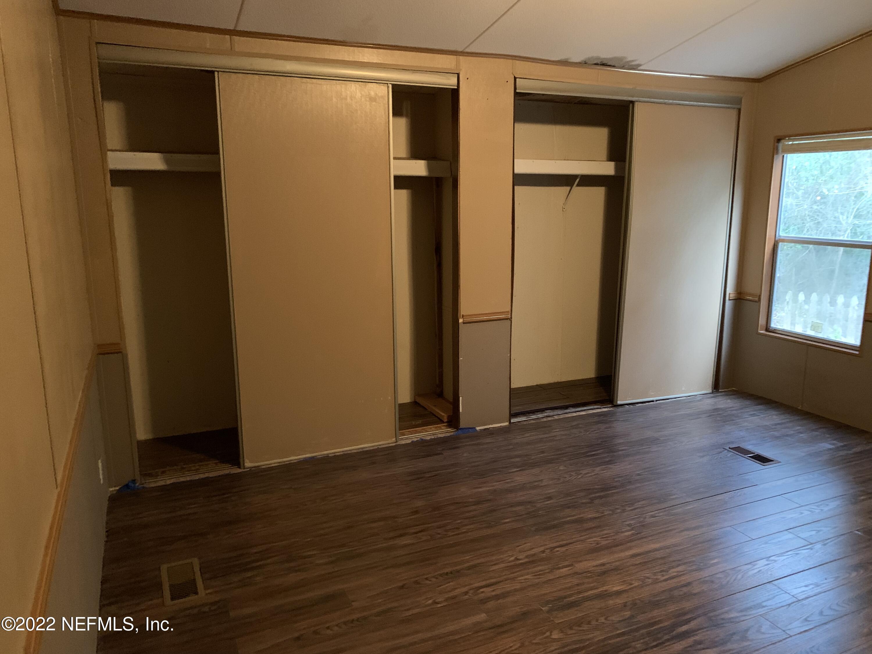 3163 Lannie Road Jacksonville, FL 32218 - Photo 30 of 36 an empty room with wooden floor and windows