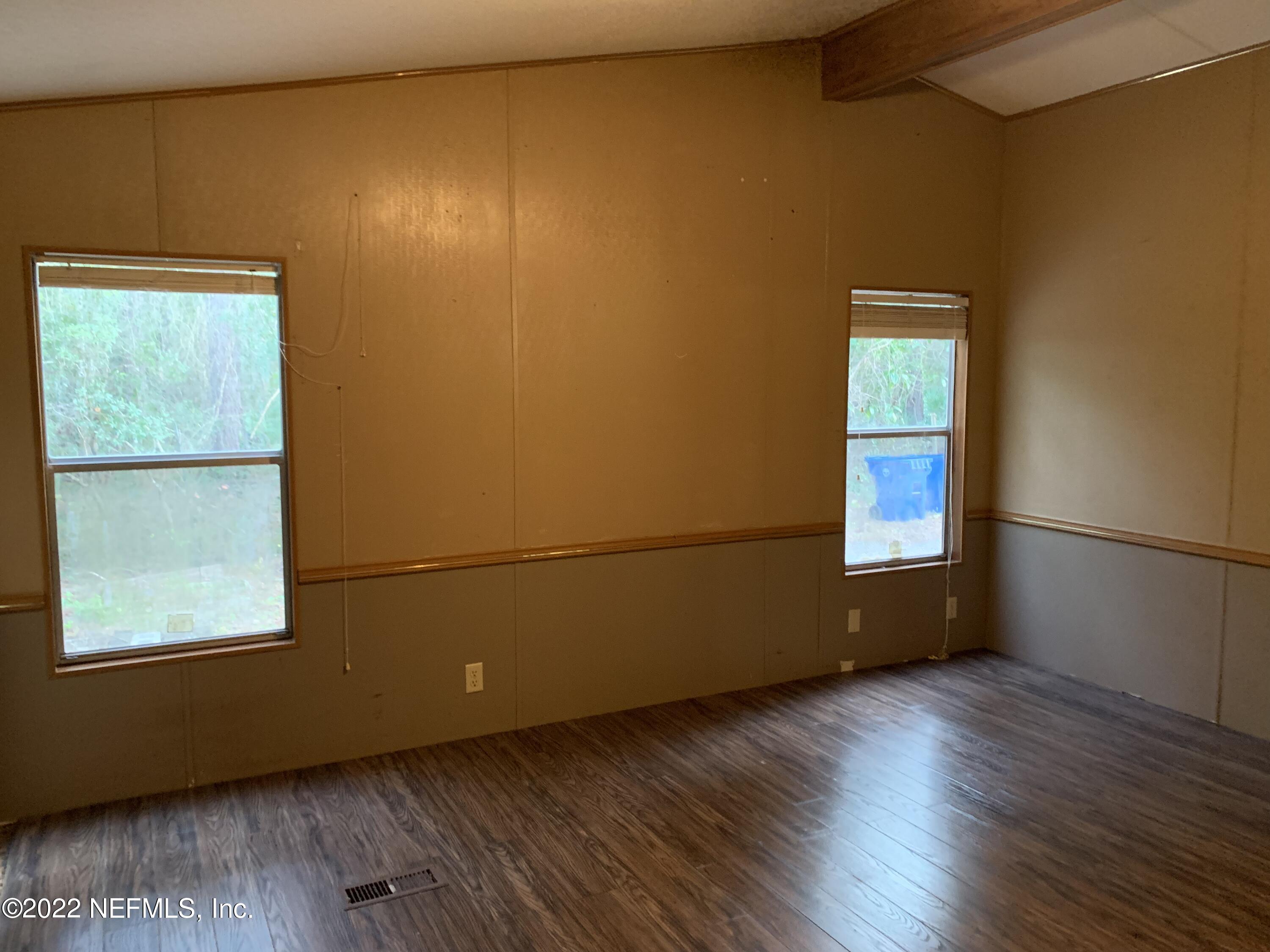 3163 Lannie Road Jacksonville, FL 32218 - Photo 31 of 36 an empty room with wooden floor and windows