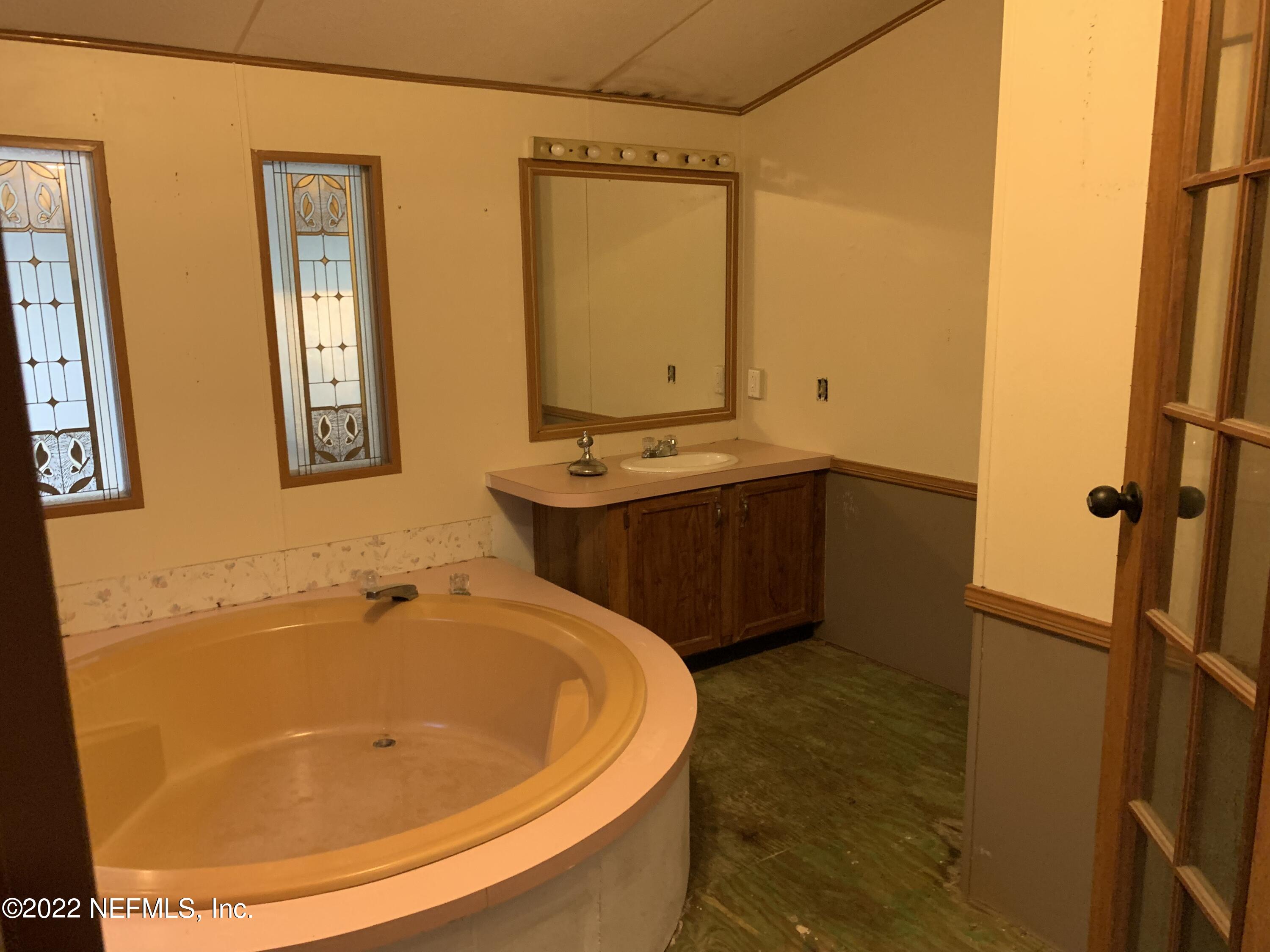 3163 Lannie Road Jacksonville, FL 32218 - Photo 34 of 36 a bathroom with a tub and sink