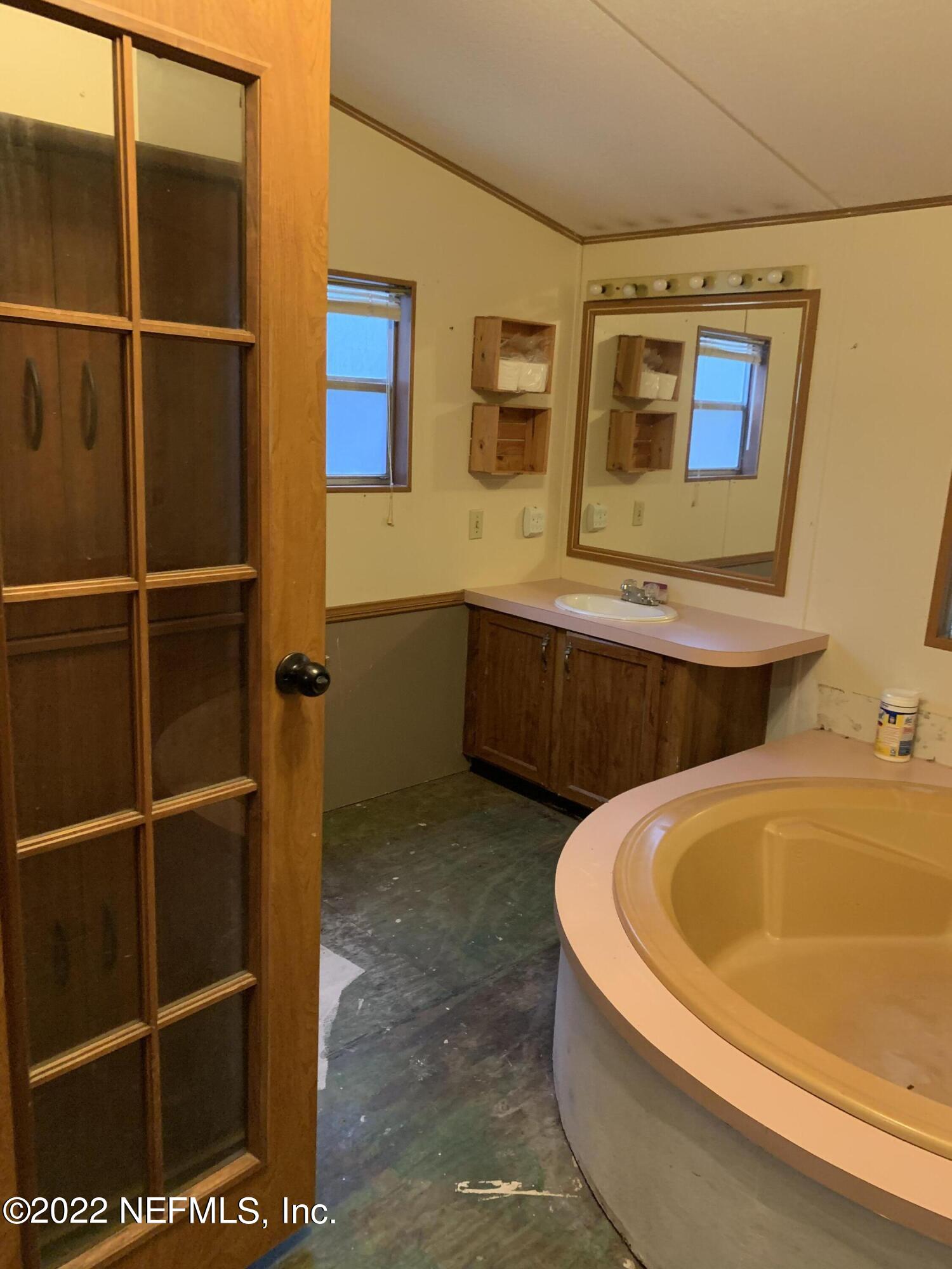 3163 Lannie Road Jacksonville, FL 32218 - Photo 35 of 36 a bathroom with a tub and sink