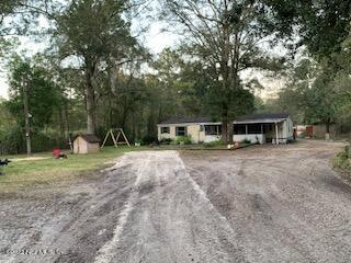 3163 Lannie Road Jacksonville, FL 32218 - Photo 4 of 36 a view of a house with backyard and trees
