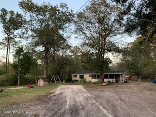 3163 Lannie Road Jacksonville, FL 32218 - Photo 5 of 36 a view of a house with backyard and trees