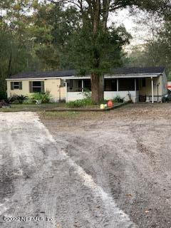 3163 Lannie Road Jacksonville, FL 32218 - Photo 7 of 36 a front view of a house with a yard and trees