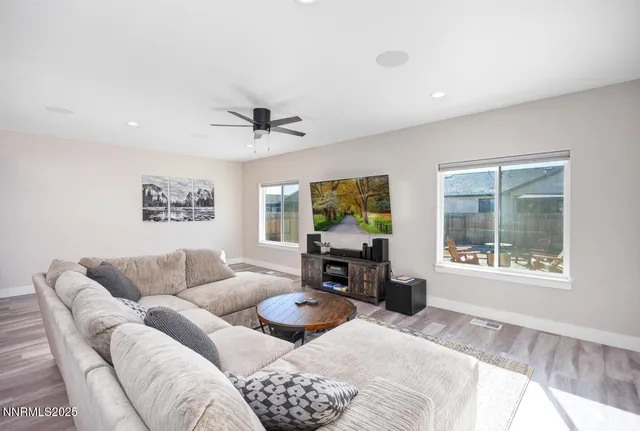 a living room with furniture a window and a flat screen tv
