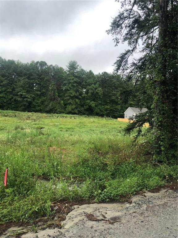 857 Townsend Road, Unit 3 Hendersonville, NC 28792 - Photo 5 of 6 a view of a field with an trees