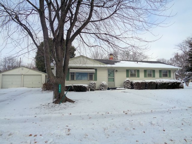 102 Cleveland Avenue Rochelle, IL 61068 - Photo 1 of 14 a front view of a house with a yard covered in snow
