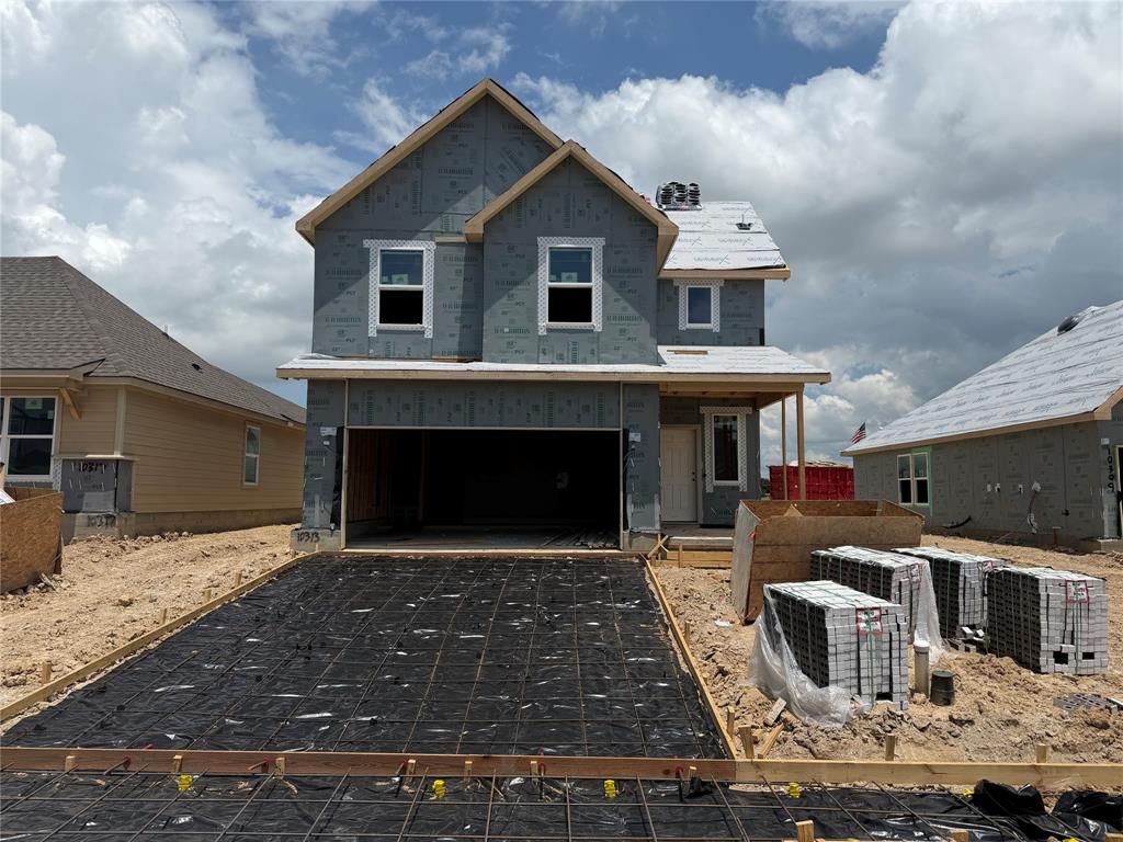 10313 Neptune Court Waco, TX 76708 - Photo 1 of 17 Two-story residential structure featuring a covered front porch, an attached two-car garage, and multiple window openings