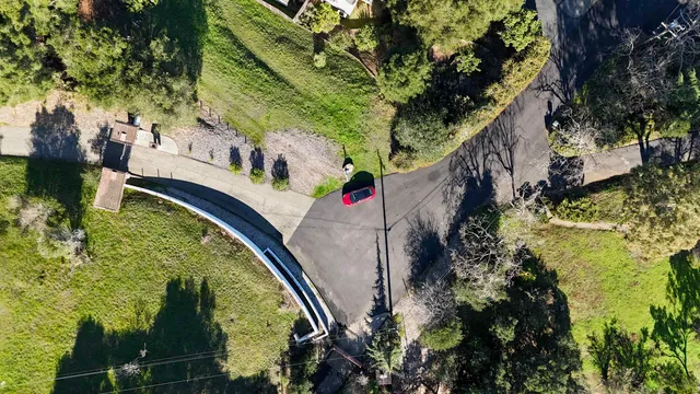 an aerial view of a house with a yard