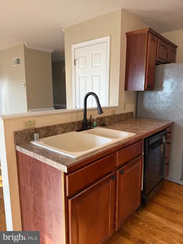 a kitchen with granite countertop a stove cabinets and a sink