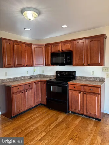 a view of a balcony with wooden floor and fence